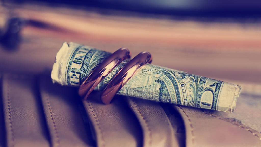 Recognizing the 17 Warning Signs of a Failing Marriage 9 stock photo gold wedding rings so close and a dollar vintage