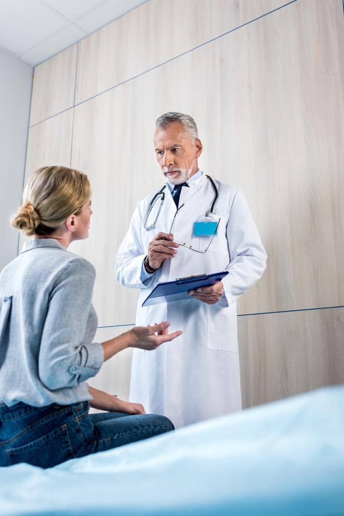 Empathic Rupture: When the Essential Bond of Empathy Breaks 4 female patient gesturing hand talking male doctor clipboard