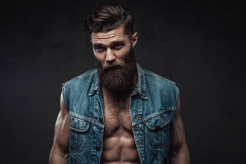 Fragile Masculinity: The Root of Controlling Behavior in Relationships 2 cool bearded man in jeans jacket posing in studio