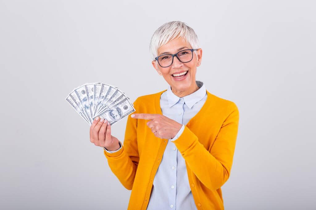 10 Hidden Financial Advantages of Being Single After Divorce 14 happy senior woman holding lots cash
