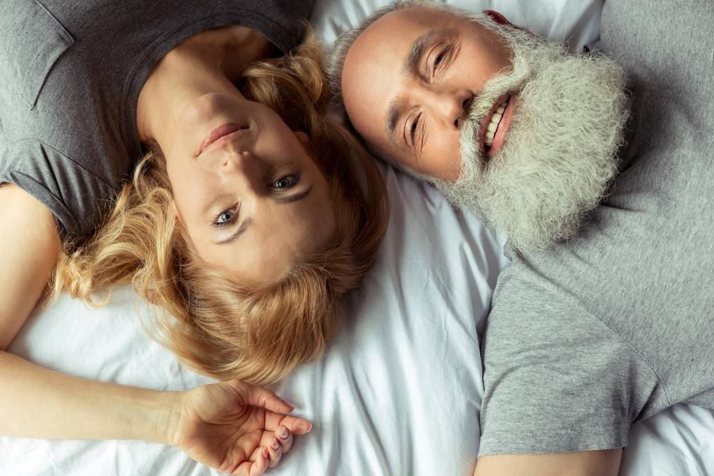 15 Clear Signs You're Not Ready for a Relationship 12 Middle aged couple in bed