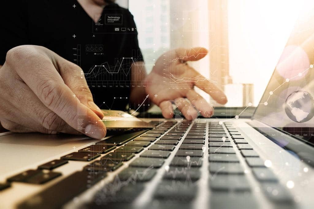 Identity Theft: You Can't Afford to Overlook These 9 Signs 2 hands using laptop and holding credit card with digital layer effect diagram as Online shopping concept