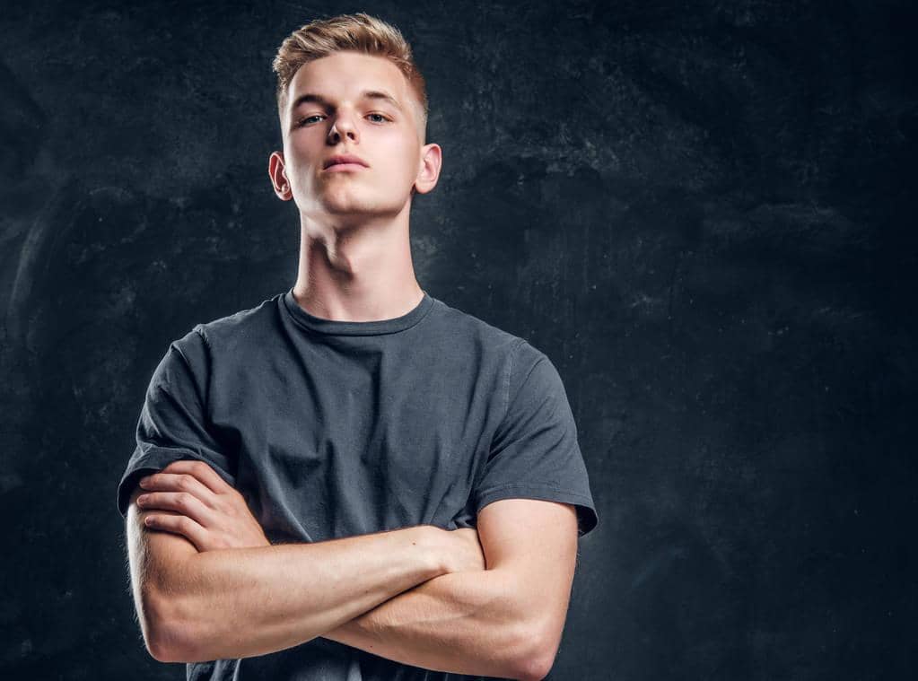 Narcissism Uncovered: 10 Toxic Traits of a Narcissist You Can’t Ignore 6 Young arrogant male is looking to the camera crossed his hands over dark background.