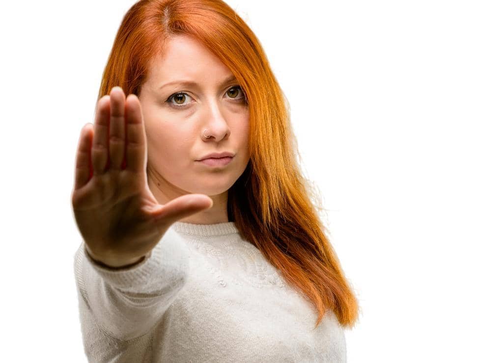 3 Secret Clues Your Body Is Rejecting Someone 10 beautiful young redhead woman annoyed bad attitude making stop sign