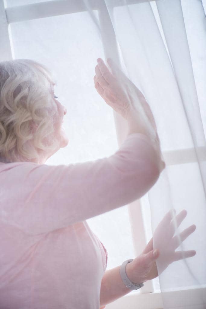The 11 Unexpected Silver Linings of a Gray Divorce 2 senior woman at window
