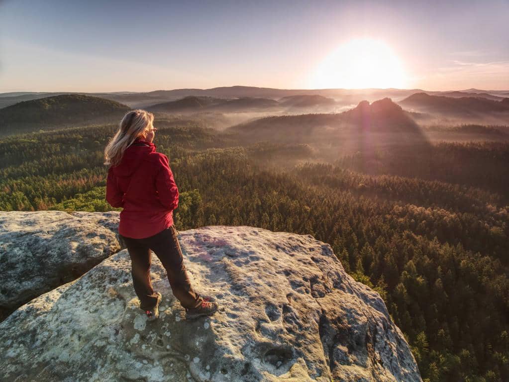 Stages of Emotional Healing: 7 Challenging Steps Toward Growth 8 woman in outdoor clothes enjoy view at summit in mountains