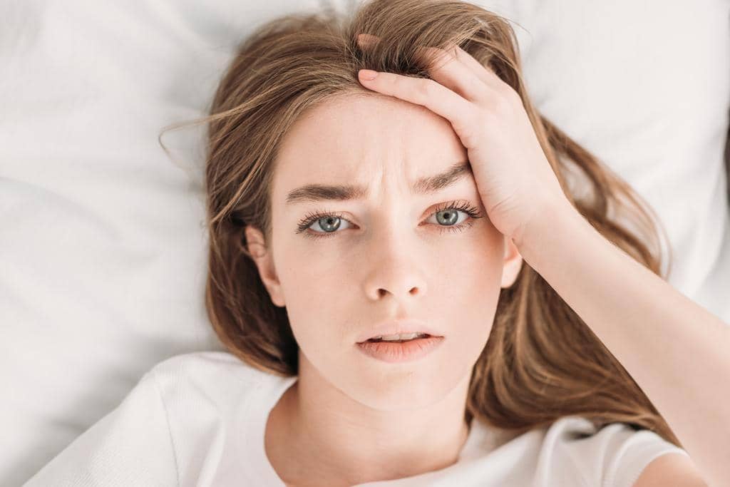 How Indifference in Relationships Can Ruin, or Save It 7 young woman looking camera while suffering headache