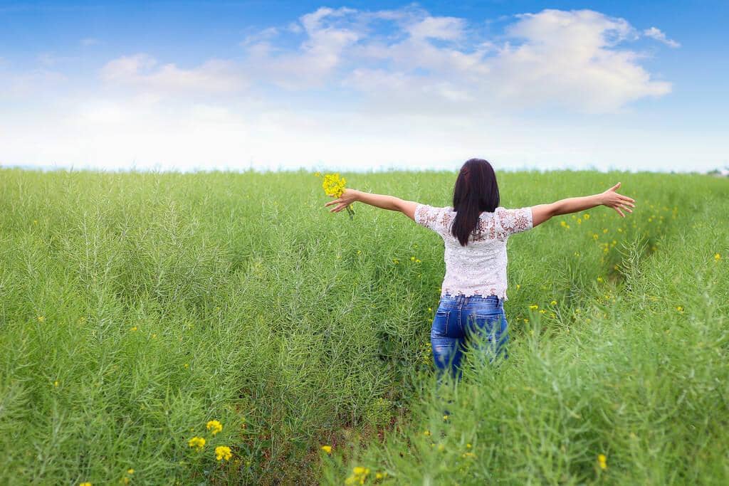 Closure After Divorce: 9 Painful Truths About Letting Go Gracefully 11 girl green field raises his hands freedom