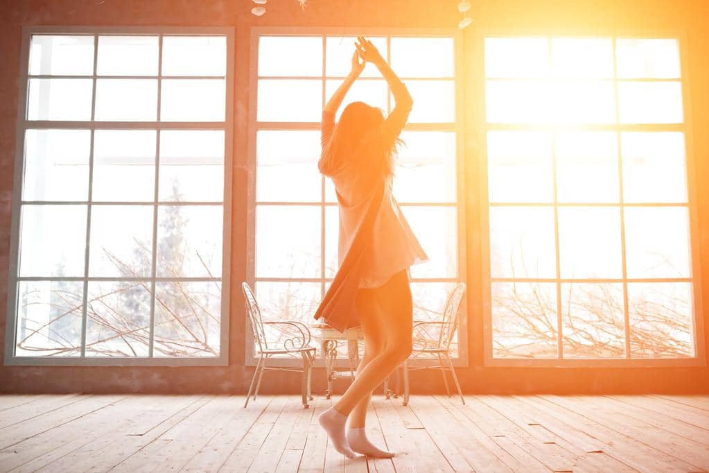 Fantasizing About Living Alone? These 10 Truths Hit Hard 2 young woman dancing near huge wondows at her apartment