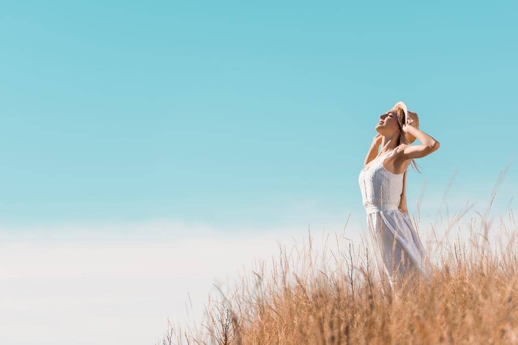 Fantasizing About Living Alone? These 10 Truths Hit Hard 7 young woman white dress touching straw hat