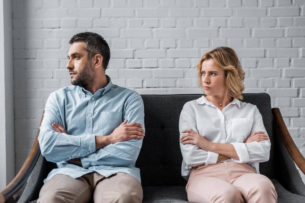Roommates or Deep Connection: 15 Eye-Opening Comparisons 9 angry couple sitting couch quarrel looking away