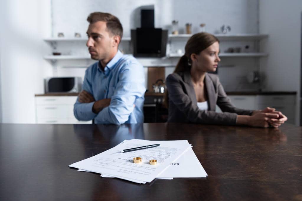 High Conflict or Legal Abuse During Divorce? 5 Differences 5 couple sitting table divorce documents 1