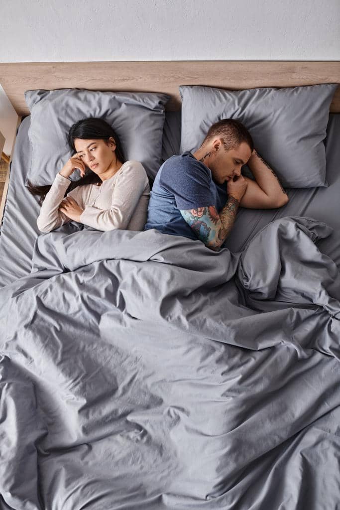 Guide to Honest Divorce Talk: 5 Examples and Possible Reactions 16 high angle view depressed interracial couple lying bed home family