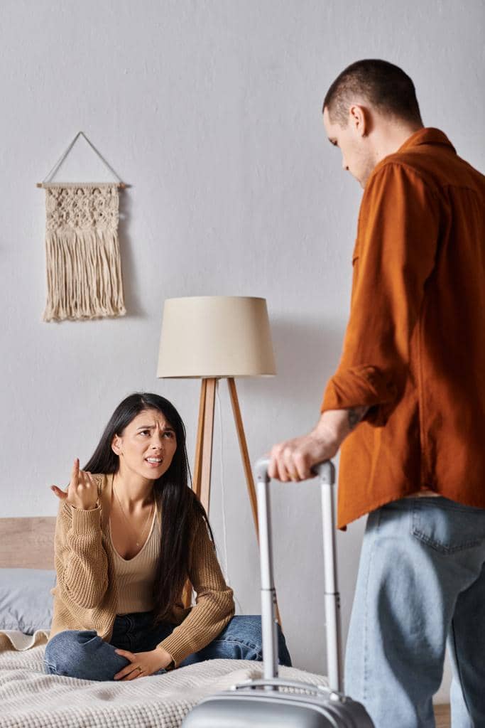 Guide to Honest Divorce Talk: 5 Examples and Possible Reactions 6 irritated asian woman sitting bed quarreling husband suitcase home divorce