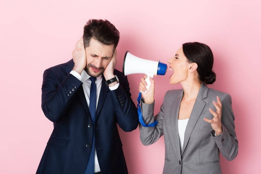 Can Opposing Political Views Destroy a Relationship? 13 stock photo emotional woman screaming megaphone bearded businessman covering ears pink
