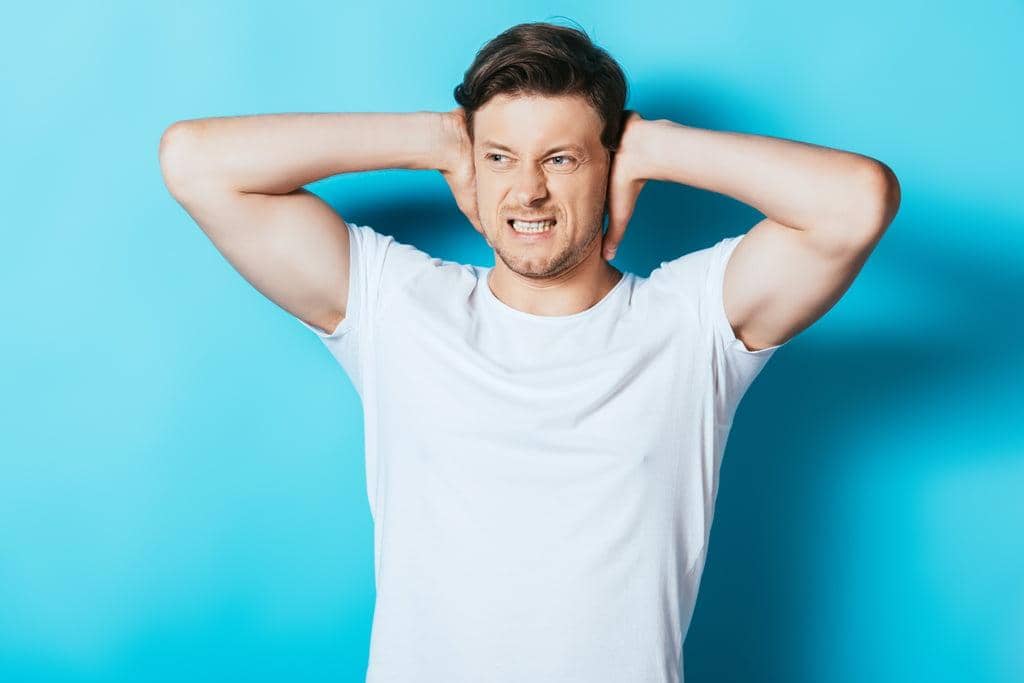 Anger in Marriage: 15 Critical Warnings Your Husband’s Rage Is Tearing You Apart 4 angry man white shirt covering ears hands blue background