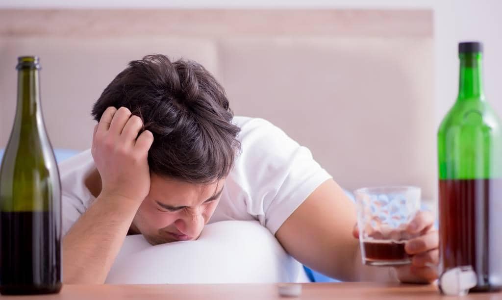 30 Ways to Protect Yourself From an Angry Drunk 4 man alcoholic drinking in bed going through break up depression