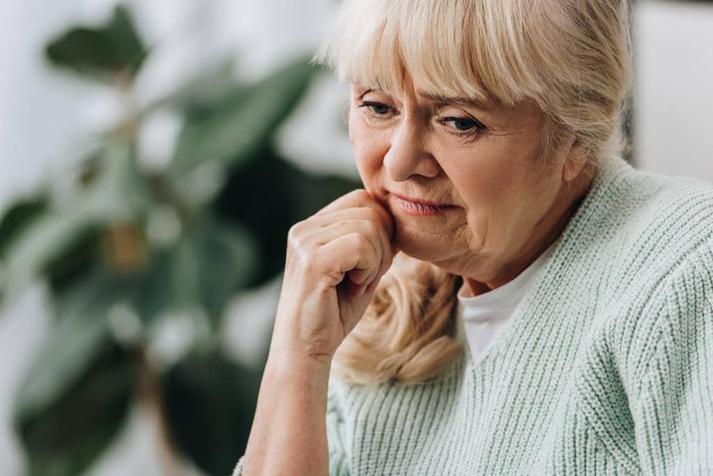 Late Life Divorce: 5 Significant Emotional Survival Challenges 7 pensive blonde senior woman living room
