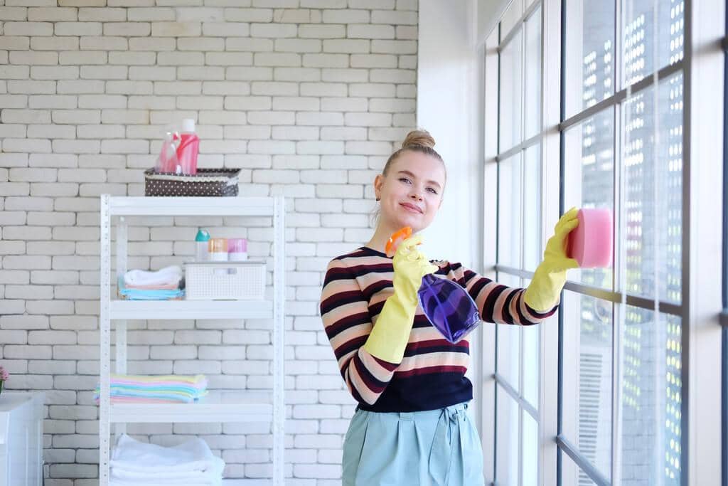 7 Surprising Ways Good Wife Syndrome Leads to Divorce 10 smiling young caucasian woman wear yellow rubber gloves holding cleanser