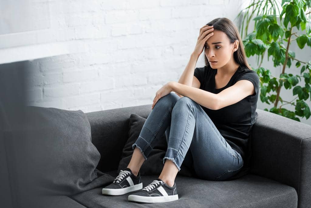 9 Clear Signs He’ll Fail As A Life Partner 11 pretty young woman suffering depression while sitting couch home holding