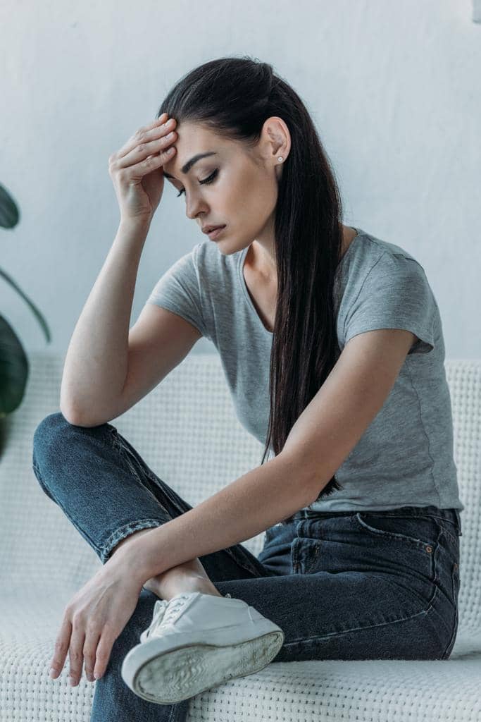 The 7 Mental Struggles of a Dry Marriage 2 upset young woman hand forehead sitting couch looking