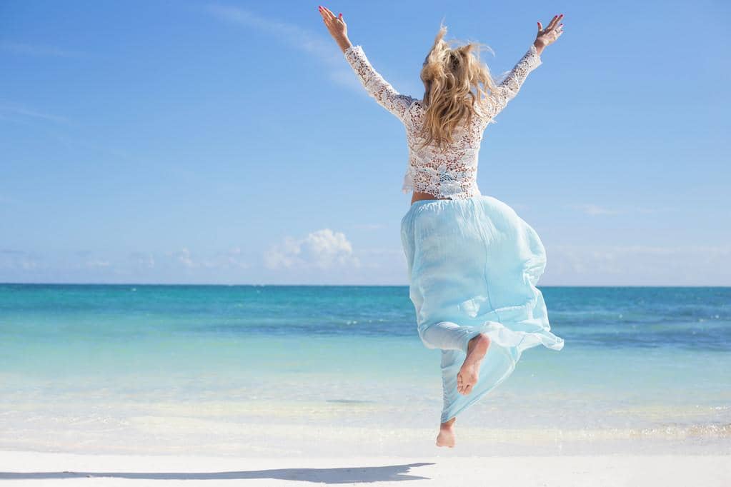 The 11 Unexpected Silver Linings of a Gray Divorce 14 woman enjoying vacation