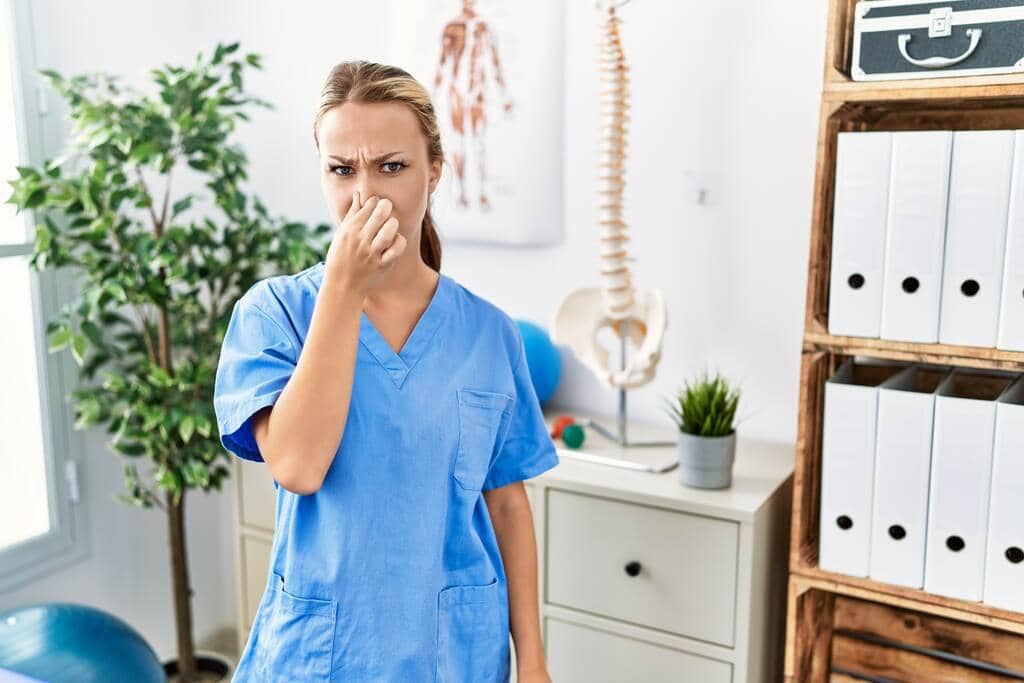 How to Discuss Your Husband's Hygiene Without a Fight 4 caucasian woman working pain recovery clinic smelling something stinky