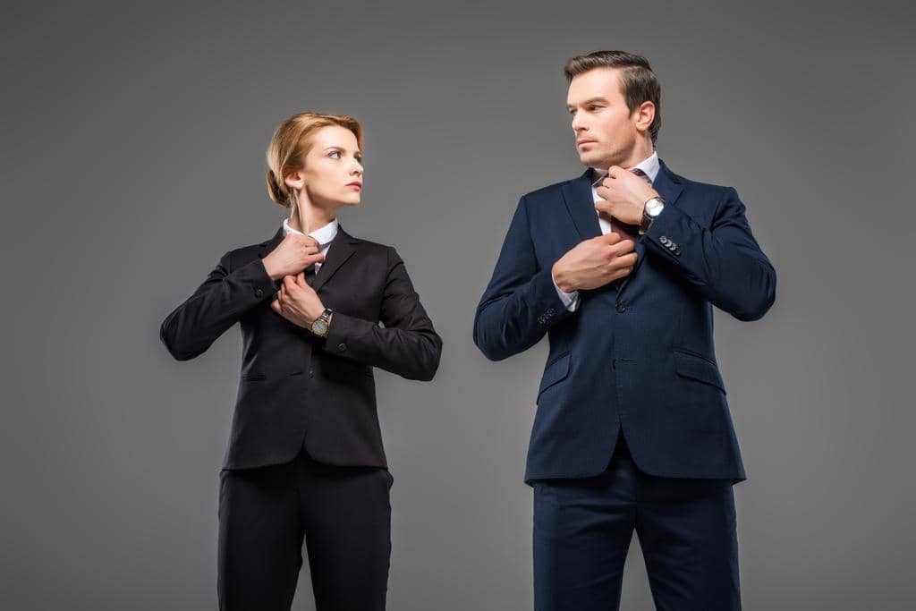 How to Discuss Your Husband's Hygiene Without a Fight 13 serious businesswoman businessman fixing ties