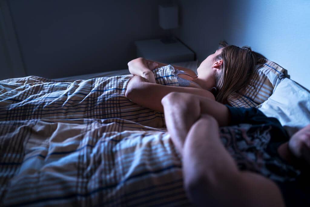 9 Outrageous Lies Men Believe to Justify Infidelity 5 couple fighting lying bed arms folded marriage conflict problems crisis