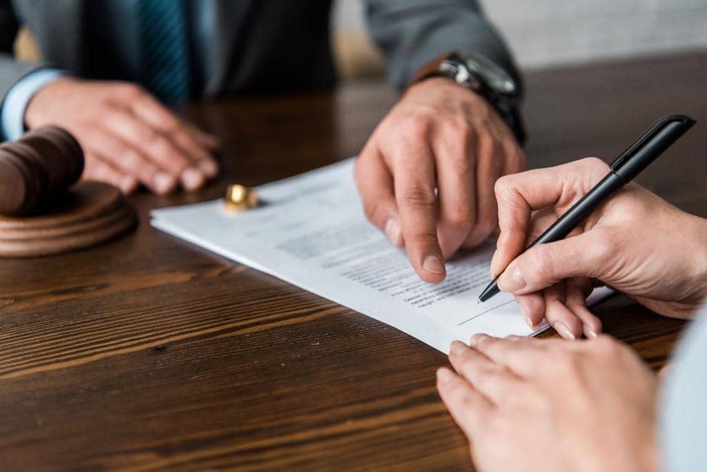 When Your Spouse Won’t Divorce You: 7 Secrets to Freedom 4 cropped shot judge pointing papers client signing divorce decree