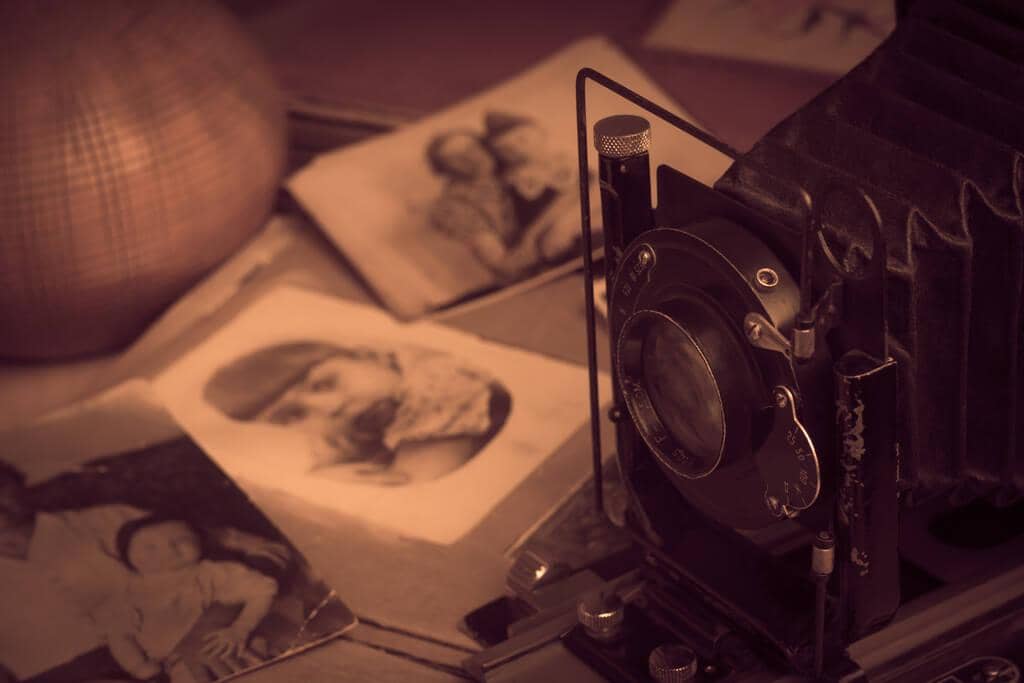 7 Devastating Financial Mistakes in Gray Divorce: How to Avoid Them 8 old photographs 1912 1919 year old photos in blur and camera on the table