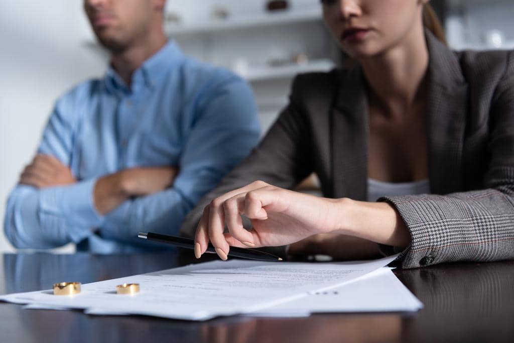 High Conflict or Legal Abuse During Divorce? 5 Differences 4 partial view couple table divorce documents