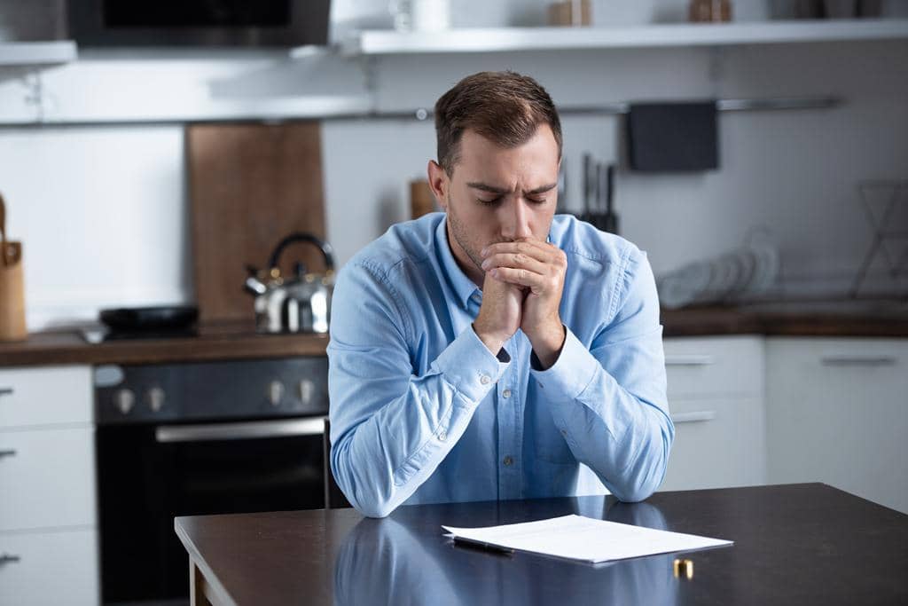 9 Reasons Men Settle for Bad Marriages: The Brutal Truth 12 sad man shirt sitting table ring divorce documents