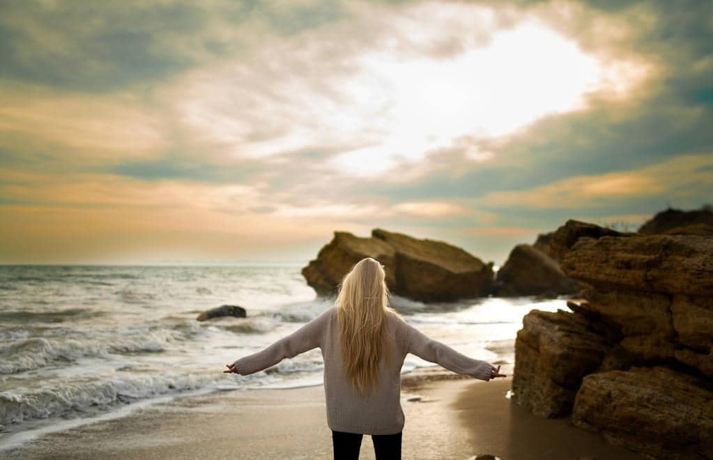 9 Absurd Reasons Why Happily Single Women Trigger Men 2 woman in sweater on winter beach at sunset