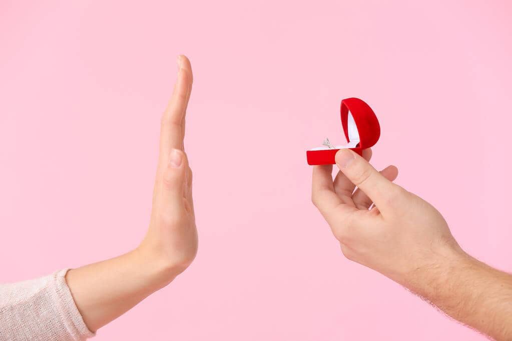 9 Absurd Reasons Why Happily Single Women Trigger Men 3 woman rejecting marriage proposal color background 1