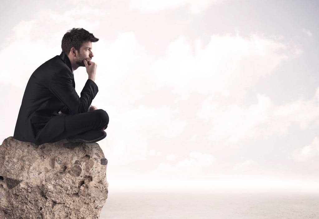 Why These 7 Sigma Male Types Are Incredible Partners 3 business man sitting on stone edge