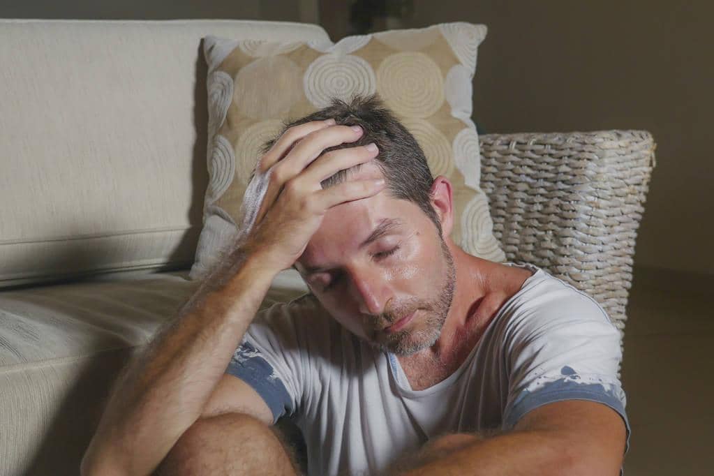 Miserable Husband Syndrome: 5 Signs Your Man Has It 7 lifestyle portrait young attractive sad and depressed man sitting on living room floor feeling desperate