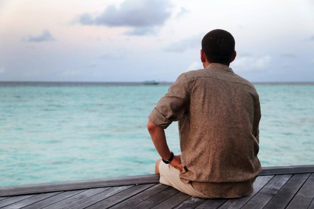 Miserable Husband Syndrome: 5 Signs Your Man Has It 2 lonely man sitting on a pier looking into the ocean 1