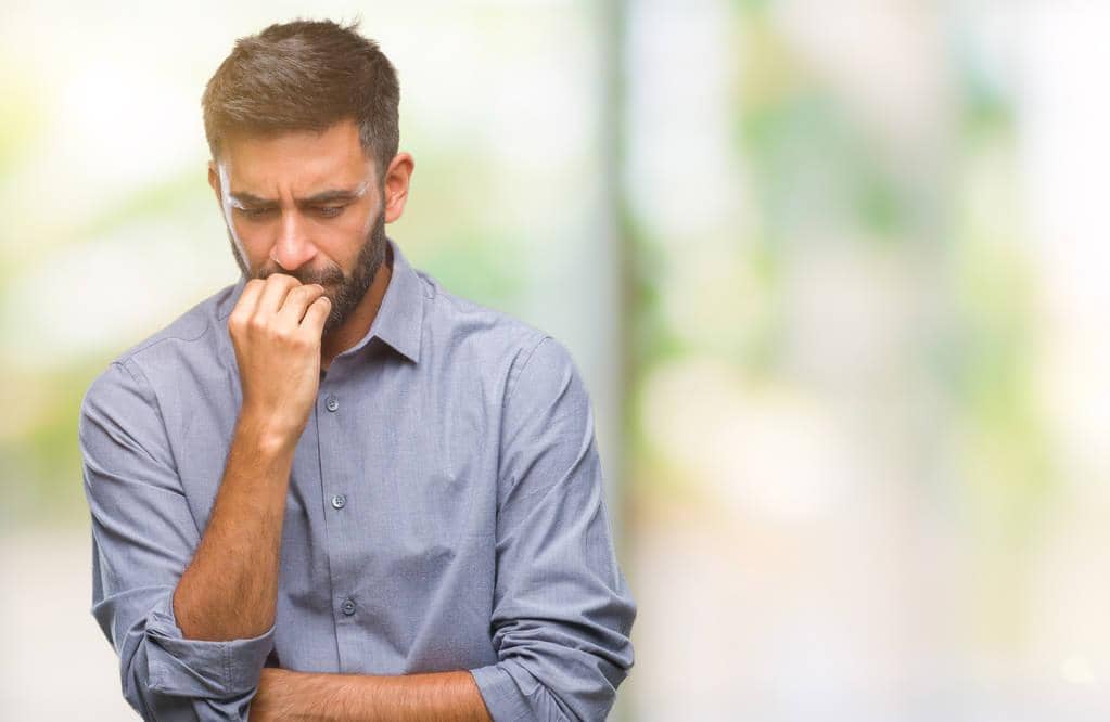 How to Discuss Your Husband's Hygiene Without a Fight 12 man isolated background looking stressed nervous insecure 1