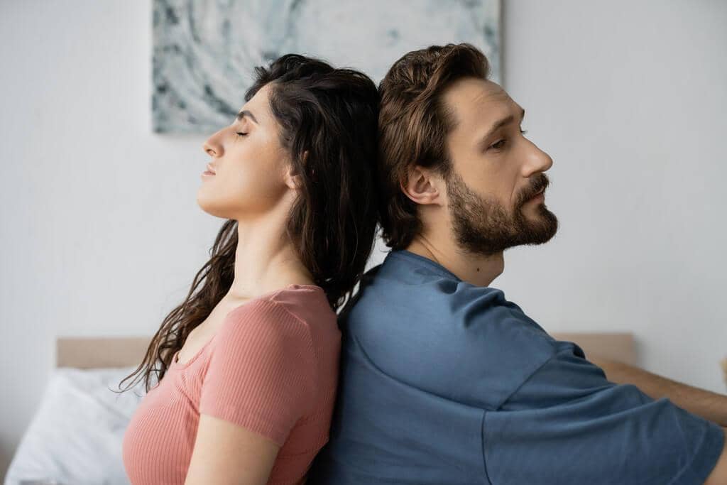 9 Clear Signs He’ll Fail As A Life Partner 4 upset bearded man sitting back back brunette girlfriend bedroom 1