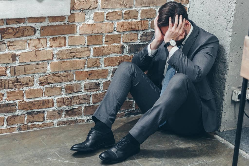 Miserable Husband Syndrome: 5 Signs Your Man Has It 8 Anxious sad man grey suit sitting corner floor crying 1