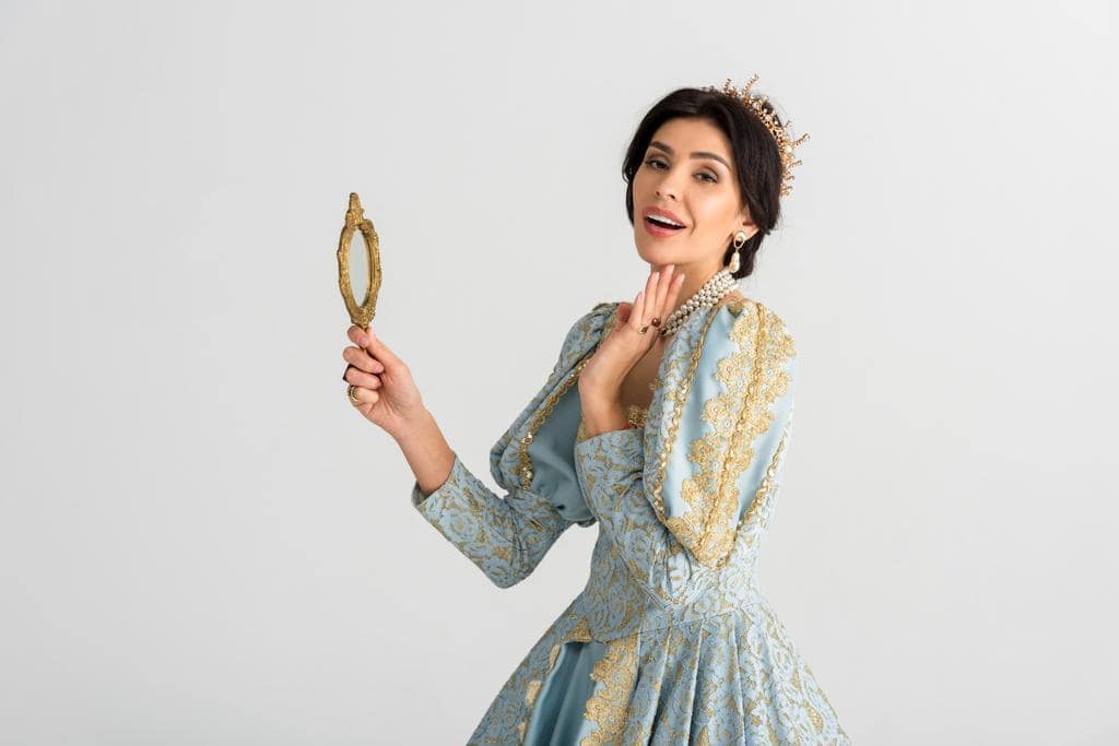 The Mystery of Princess Treatment: Who Gets It and Why 6 queen crown holding mirror isolated grey