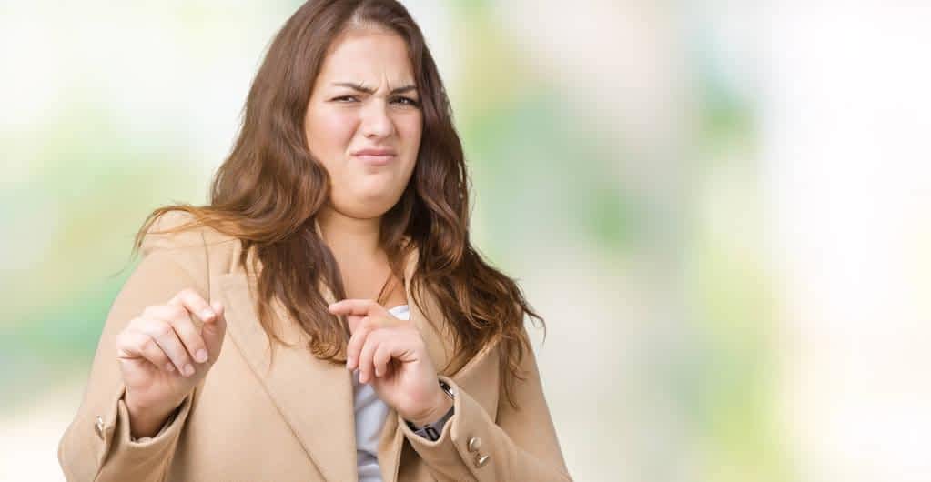 Why Men Mistake Kindness For Flirting 2 beautiful size young woman wearing winter coat isolated background disgusted