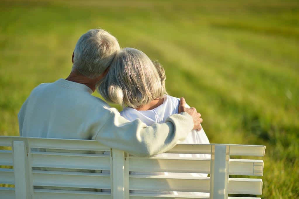 senior couple sitting on bench