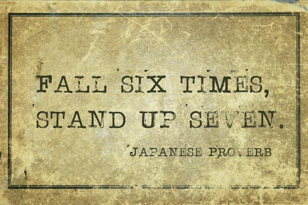 seven - ancient Japanese proverb printed on grunge vintage cardboard