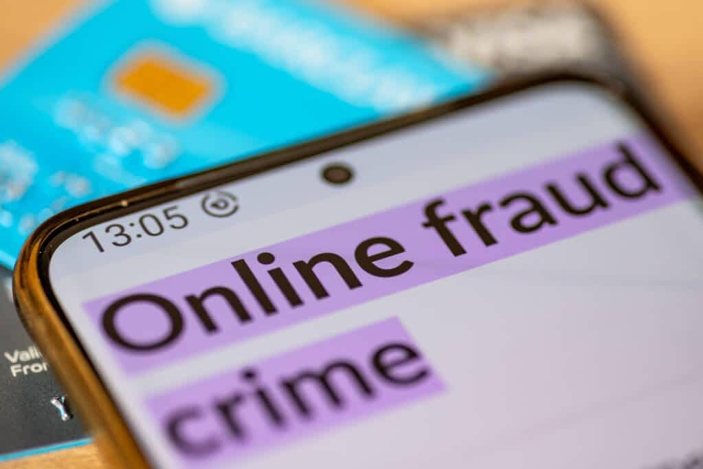 macro closeup mobile phone words online fraud crime top credit