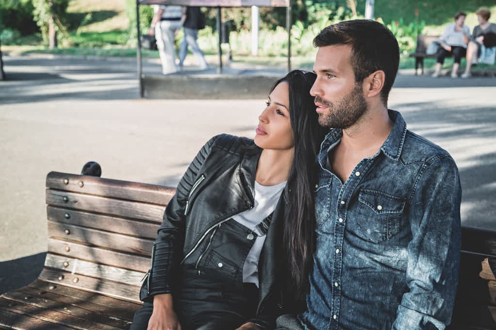 couple sitting on a park bench