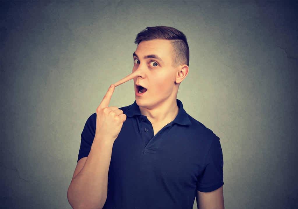 Narcissistic Psychological Blackmail: 9 Red Flags To Watch For 4 young man looking surprised camera touching long fake nose liar