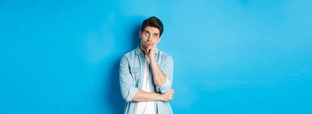 adult man rolling eyes looking bored standing indifferent blue