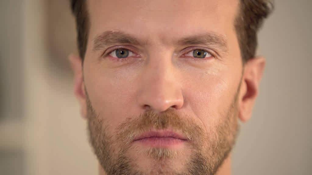 angry man looking into camera annoyed male face close up problems